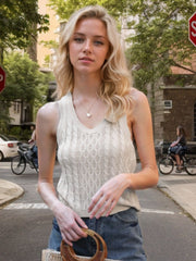 Beige cable knit tank top with V-neck and sleeveless design.