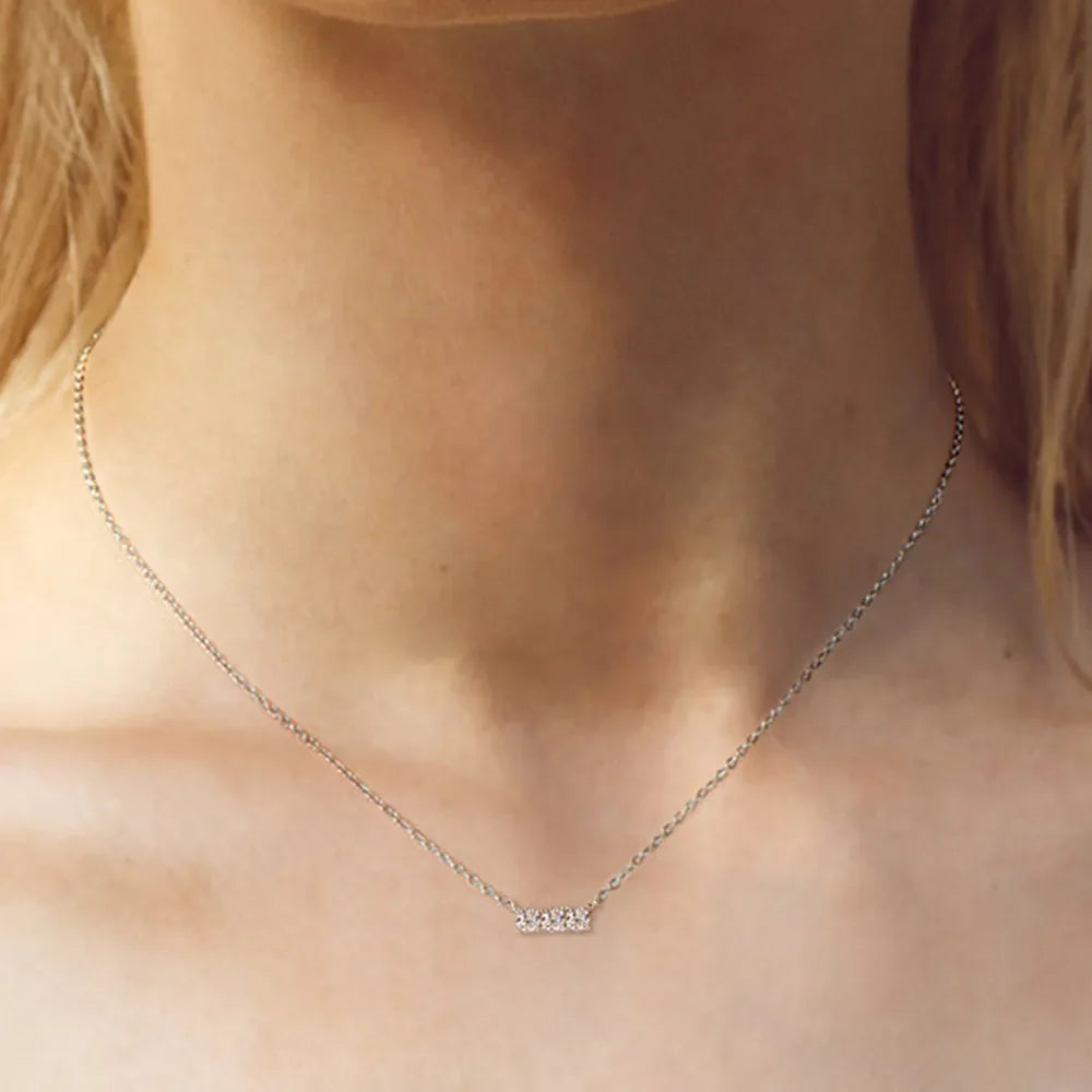 Silver bar necklace with three moissanite stones on a delicate chain