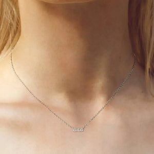Silver bar necklace with three moissanite stones on a delicate chain