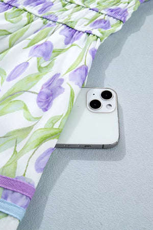 Lavender tulip print midi dress with smocked waist and hidden pocket detail.