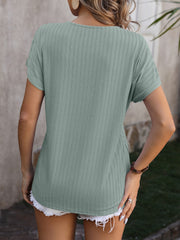 Sage green textured tee with short sleeves and a V-neck, showing the back.