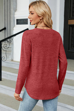 Rust marled knit long sleeve top with side button slit hem