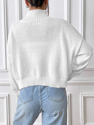 White ribbed turtleneck knit sweater with a cropped hem and relaxed fit.