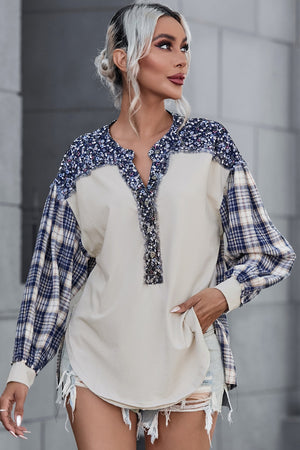 Beige mixed media blouse with floral yoke and plaid sleeves.