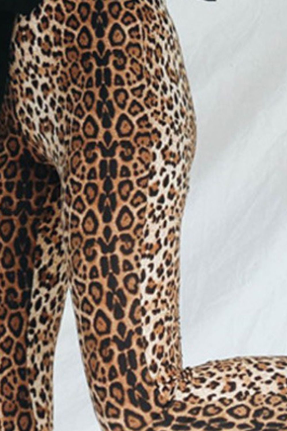 Leopard print bell bottom trousers with a flared leg.