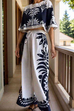 White monochrome botanical print crop top and palazzo pants set with drawstring waist.