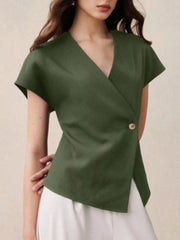 Green asymmetrical wrap shirt with cap sleeves and a single button detail.