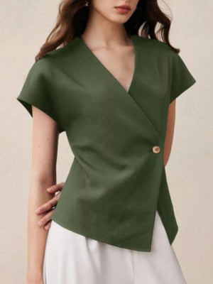 Green asymmetrical wrap shirt with cap sleeves and a single button detail.