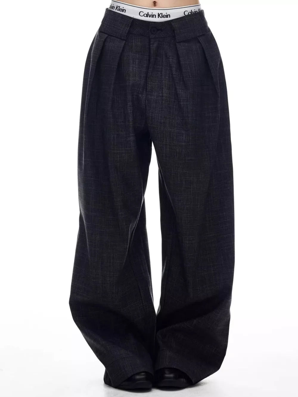 Men's dark grey wide-leg trousers with pleats and a textured fabric.