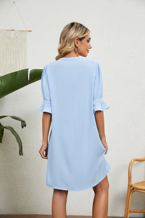 Sky blue shift dress with flutter sleeves and V-neck.