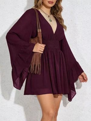 Burgundy a-line mini dress with plunging V-neck, bishop sleeves, and smocked waist.