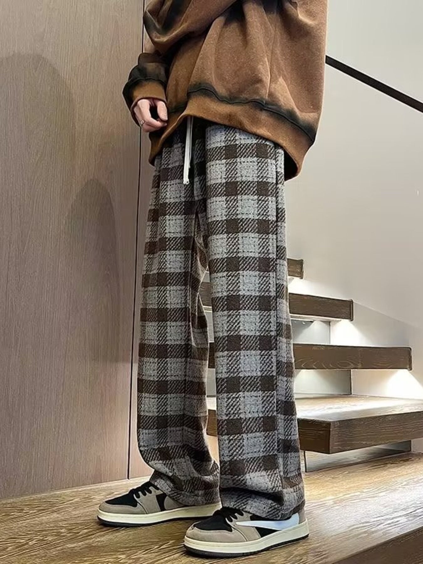 Men's wide leg plaid trousers in gray and brown, with a drawstring waist.