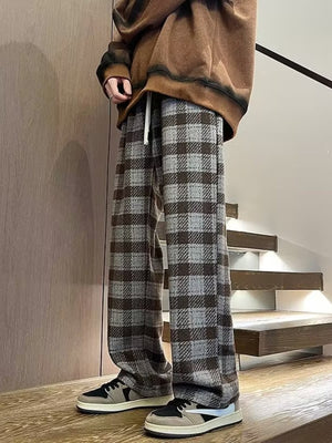Men's wide leg plaid trousers in gray and brown, with a drawstring waist.