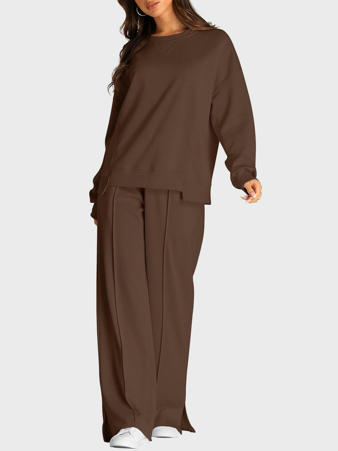 Brown seamed loungewear set with crewneck sweatshirt and slit-front wide-leg trousers.