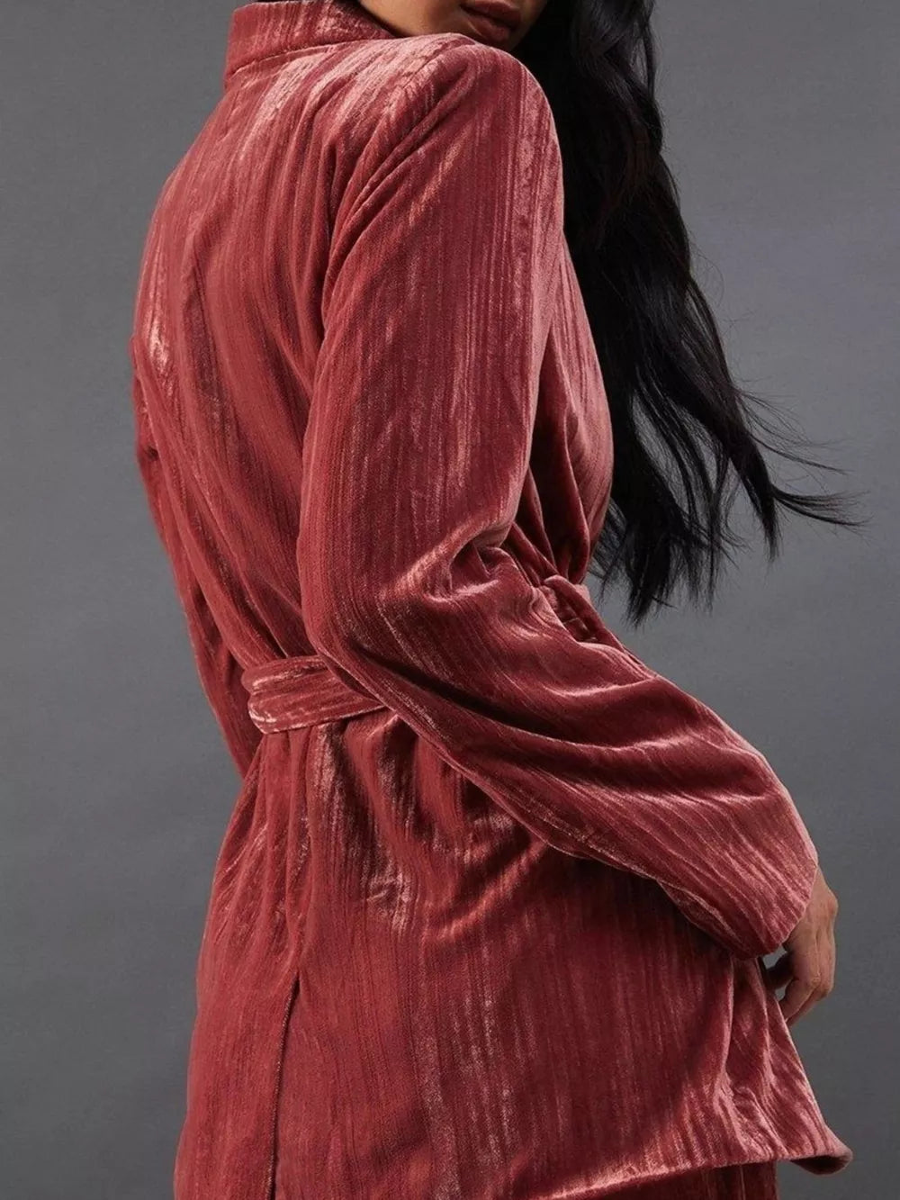 Pale Blush velvet belted blazer with textured fabric and a collared neckline.