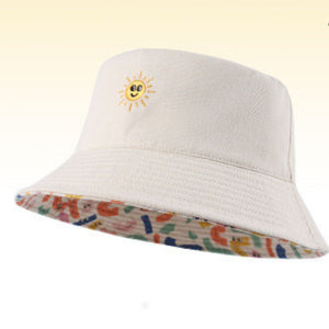 Beige cotton bucket hat with embroidered sun and abstract pattern lining