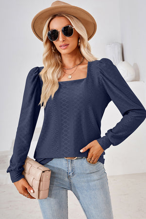 Dark blue diamond-textured puff sleeve blouse with square neckline.