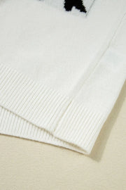 White knit tunic with black bow motif detail and ribbed hem