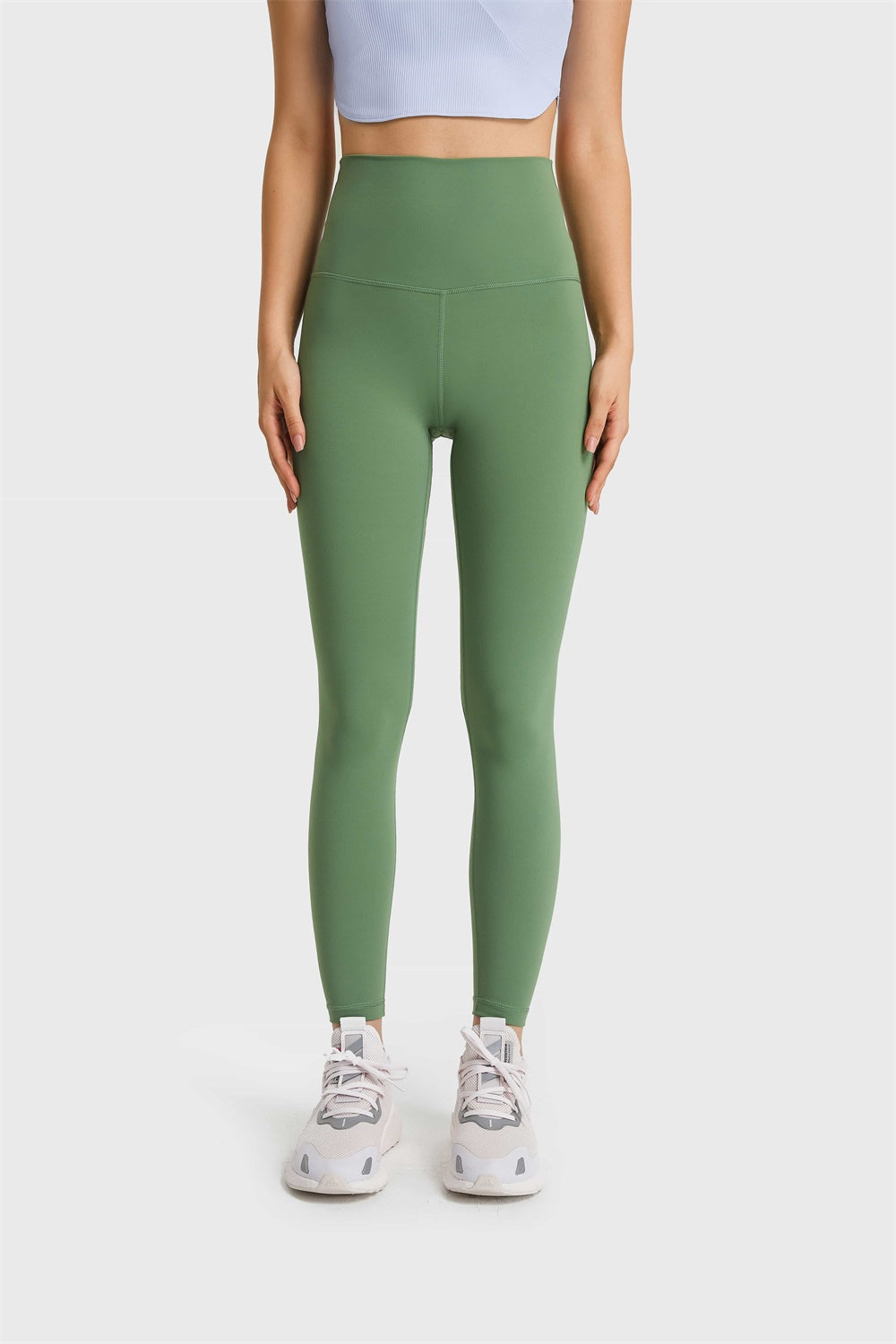 Green high rise leggings with a seamless waistband and full length legs.