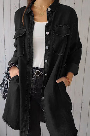 Black oversized denim shirt jacket with frayed hem and buttoned pockets.