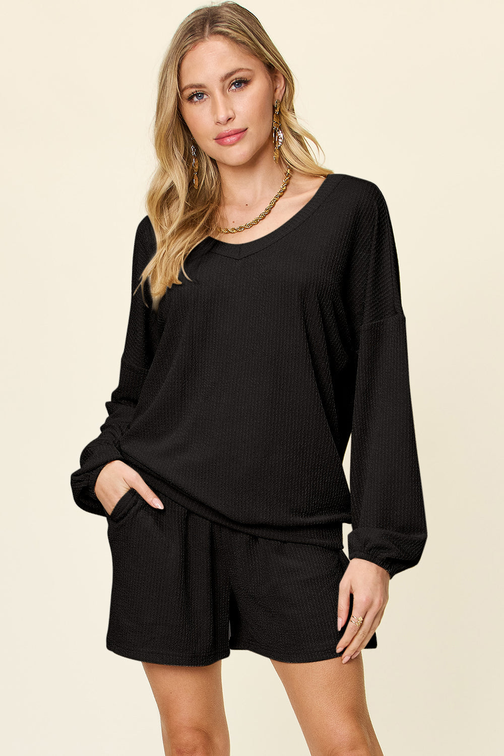 Black waffle knit lounge set with blouson sleeves and shorts.