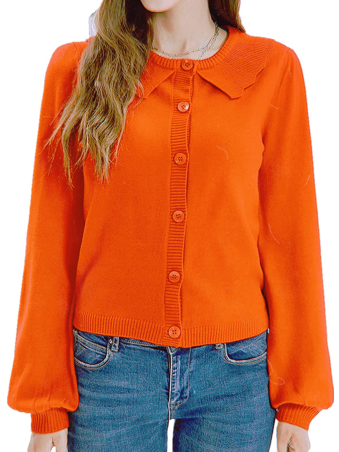 Orange knit cardigan with scalloped collar and button front, balloon sleeves.