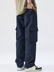 Dark blue utility-enhanced wide-leg sweatpants with cargo pockets.