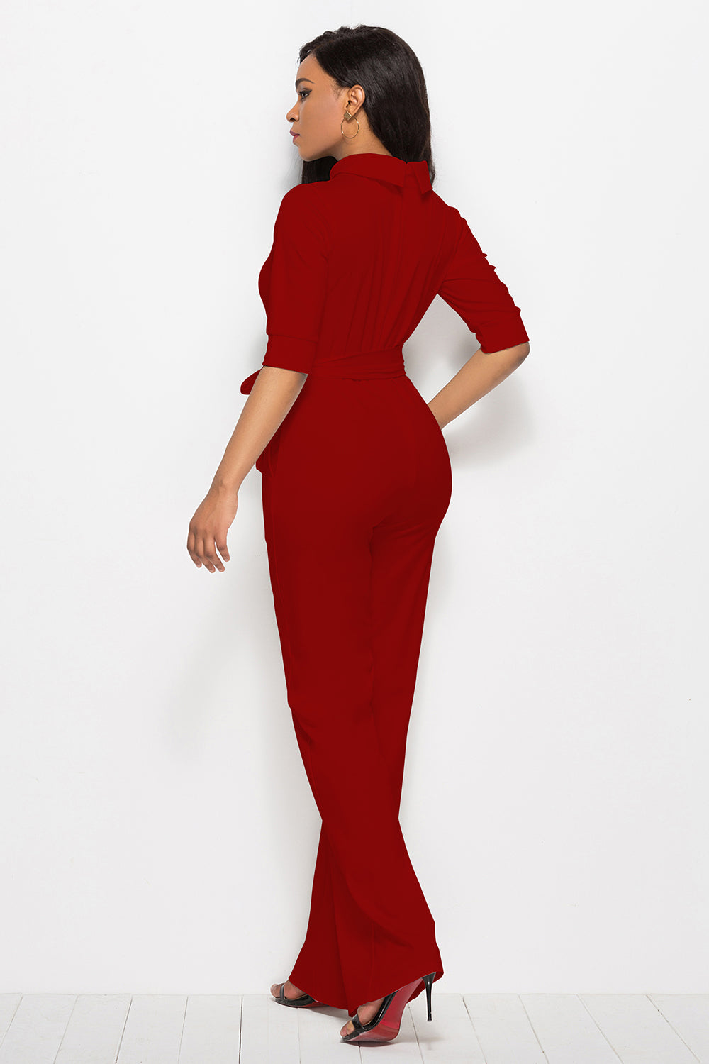 Deep Red high-neck belted palazzo jumpsuit with 3/4 sleeves and wide legs.