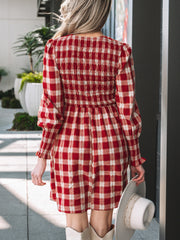 Red plaid smocked puff sleeve mini dress with cinched cuffs.
