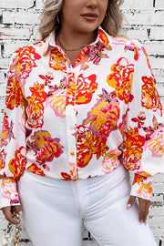Blouse with floral print, blouson sleeves, and button front, styled with white pants.