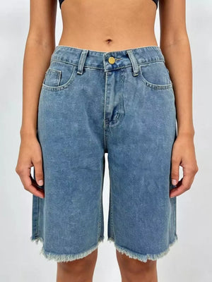 Blue denim bermuda shorts with frayed hem and relaxed fit.