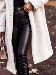 Creamy-white teddy bear longline coat with button closure, styled with black leather pants.
