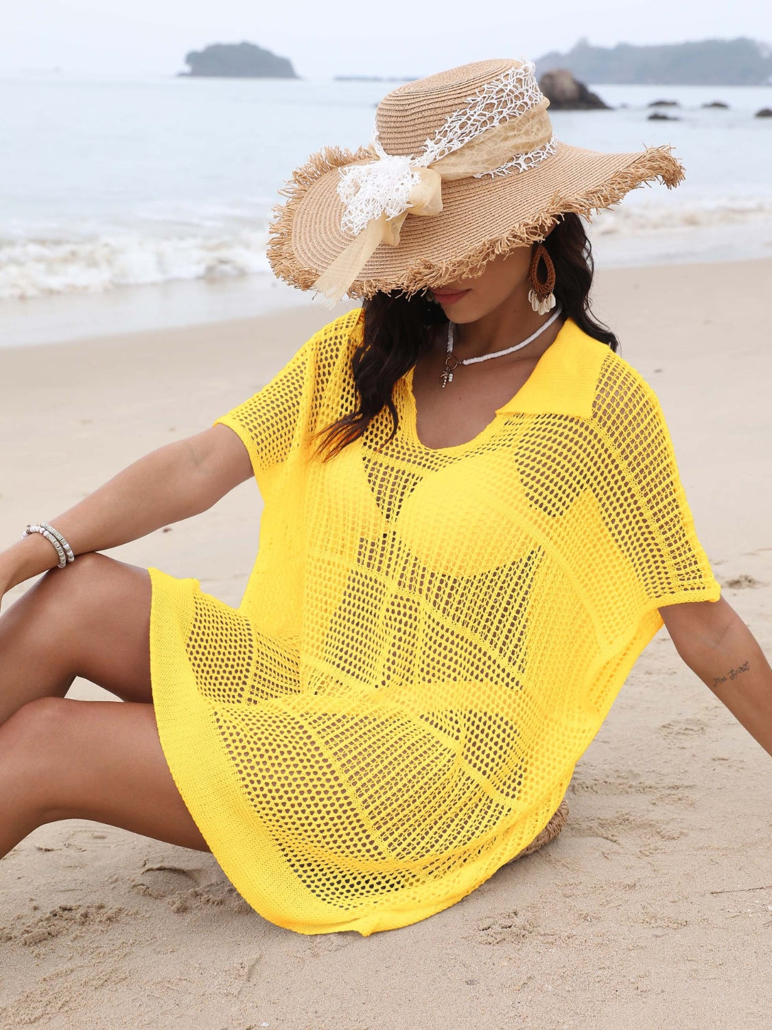 Yellow open-knit polo beach dress with short sleeves and a V-neck, styled with a straw hat.