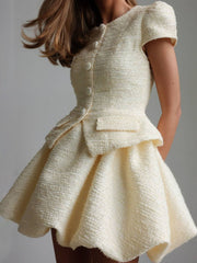 Textured cream button-down dress with short sleeves and a bubble hem skirt.