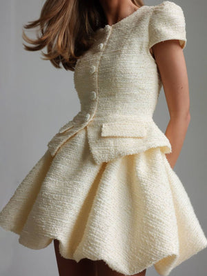 Textured cream button-down dress with short sleeves and a bubble hem skirt.