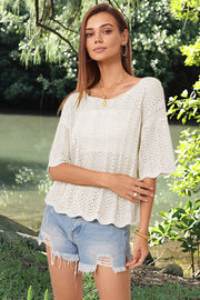 Cream open-knit top with scalloped sleeves and hem, boat neck, relaxed fit.