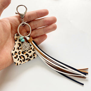 Leopard print tag charm keychain with turquoise beads, sunflower charm and multi-color tassels.