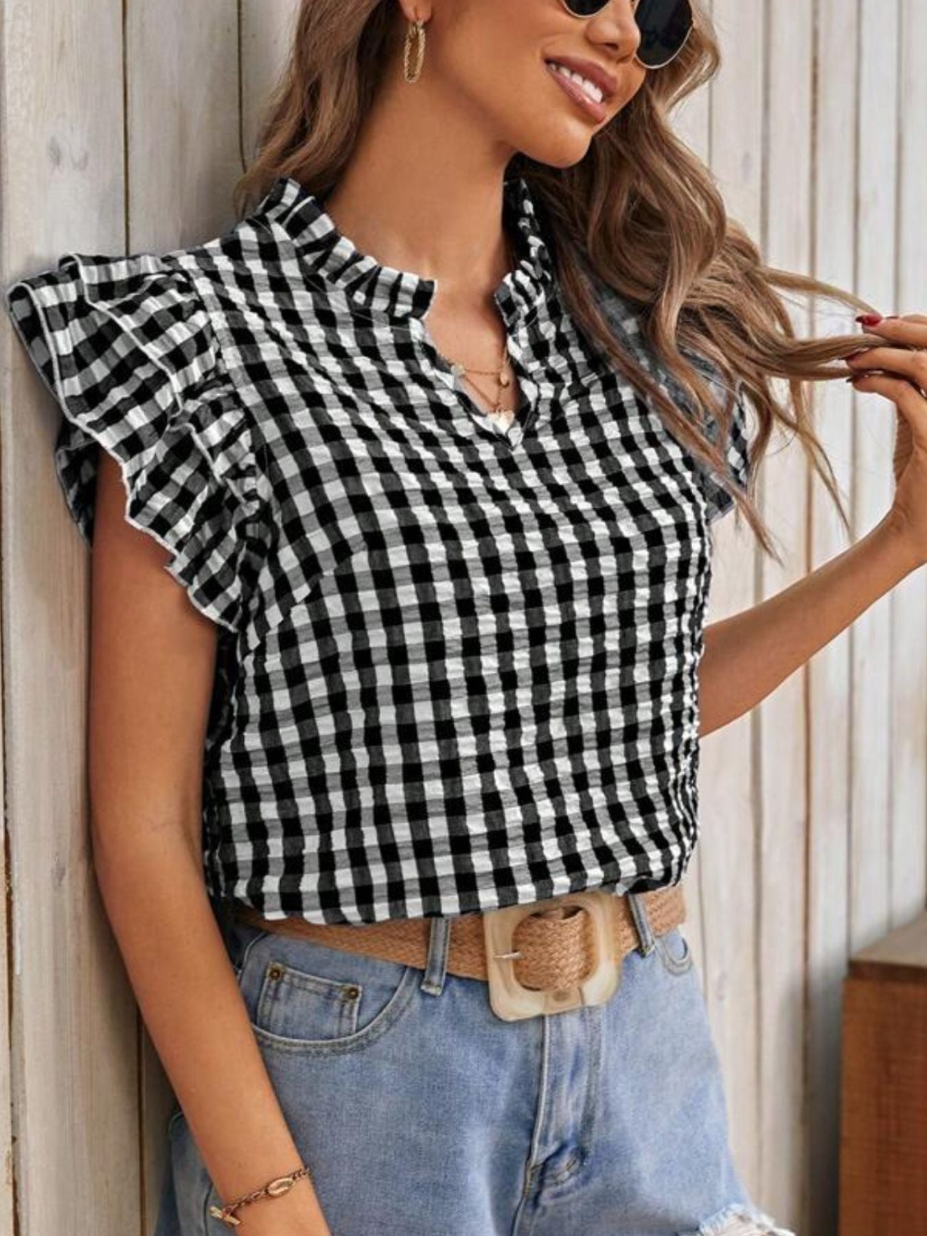 Black and white gingham ruffle sleeve blouse with a mock neck and v-neck detail.
