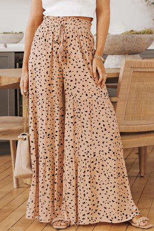 Dalmatian print palazzo trousers in watermelon pink with tiered ruffle hem and drawstring waist.