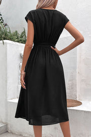 Black cap sleeve wrap midi dress with belted waist and A-line skirt.