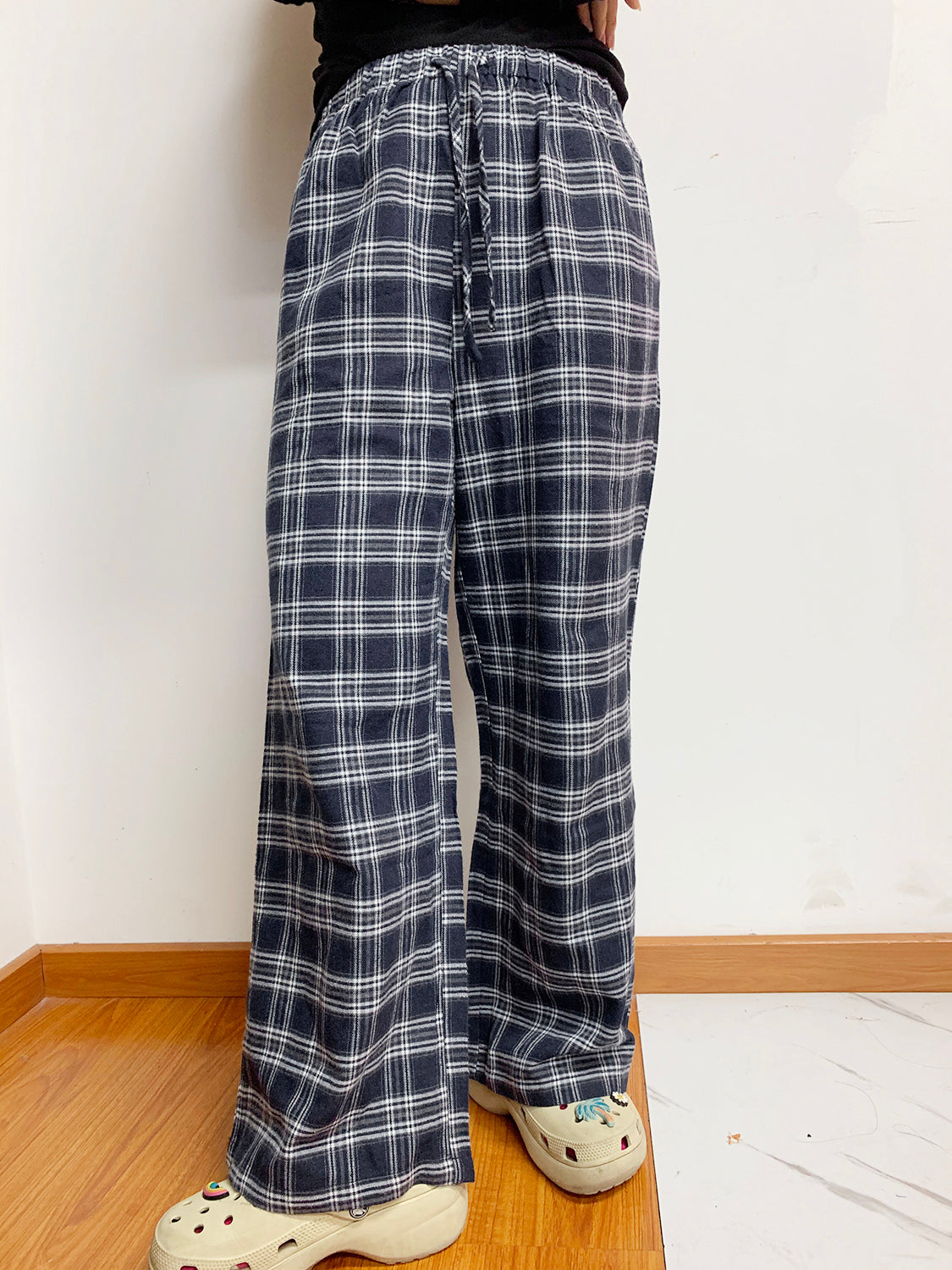 Relaxed plaid drawstring palazzo pants in dusty blue with a wide leg and casual fit.