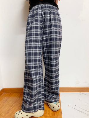Relaxed plaid drawstring palazzo pants in dusty blue with a wide leg and casual fit.