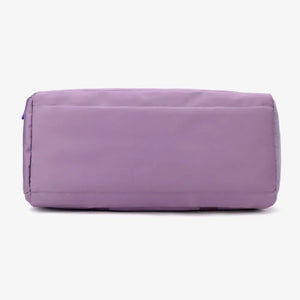 Mauve nylon duffle bag with mesh pocket detail on the side.