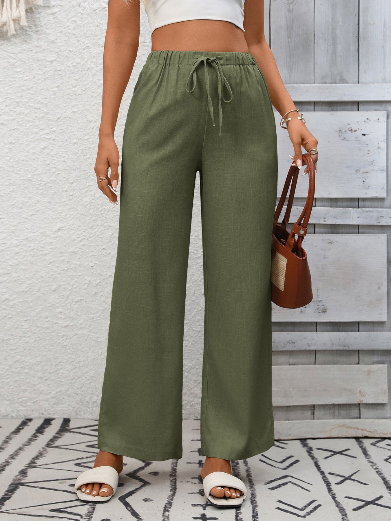 Army green high-waist wide-leg pants with drawstring detail and elastic waistband.