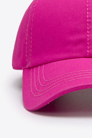Pink canvas baseball cap with stitched details on the brim and crown.