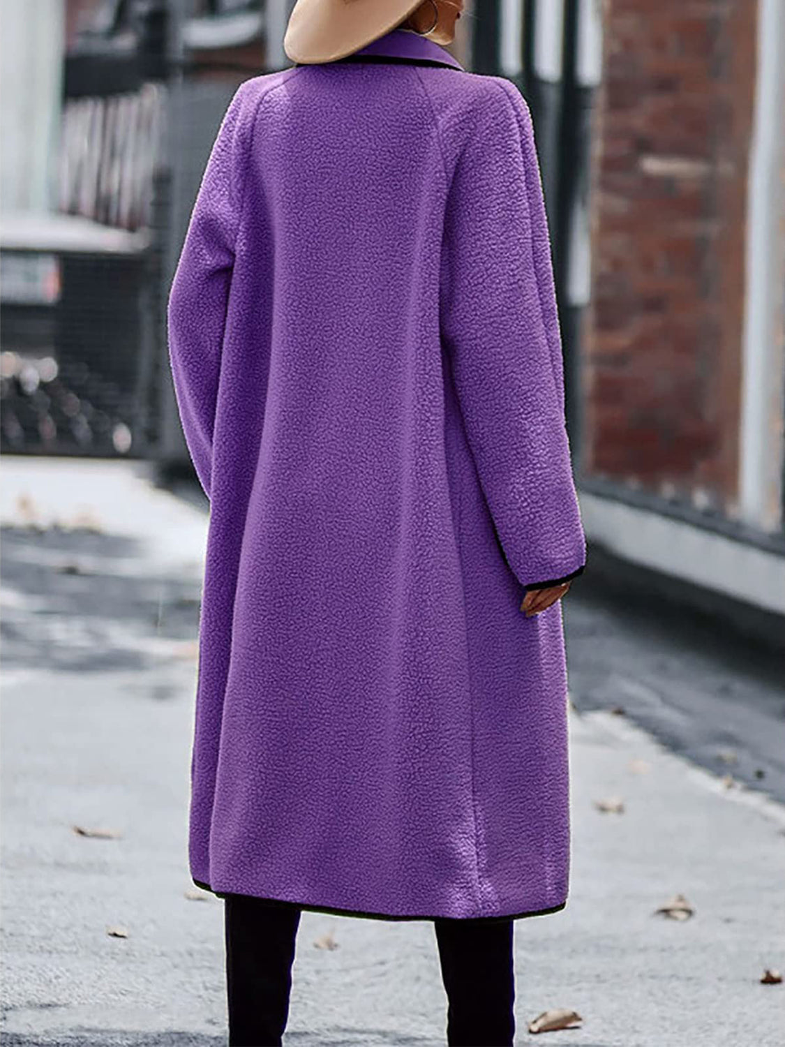 Purple teddy coat with contrast trim detailing and long sleeves.