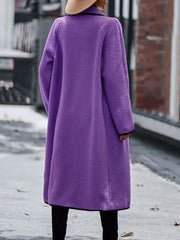 Purple teddy coat with contrast trim detailing and long sleeves.