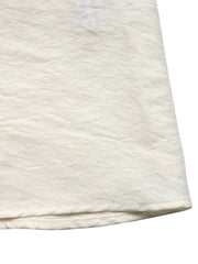 Beige maxi dress hem detail with textured fabric and subtle crinkles.
