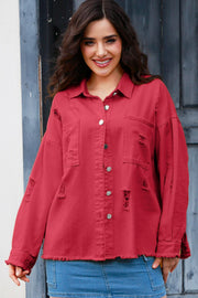 Distressed crimson denim overshirt with frayed details and silver buttons, styled casually.