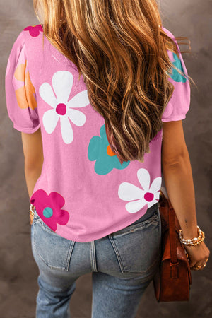 Pink puff sleeve top with white, teal, and pink floral print